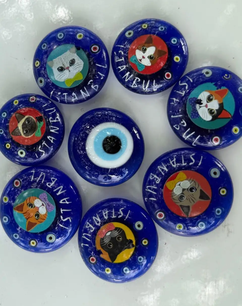 Istanbul Cat Evil Eye Magnets: round blue evil eye magnets, each with a cat.