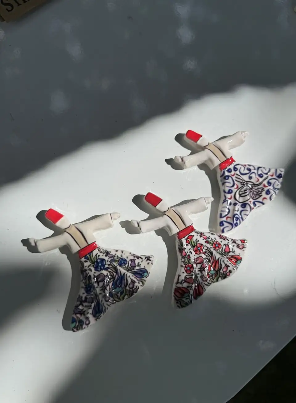 Whirling Dervish Magnet: whirling dervish figures in patterned skirts.