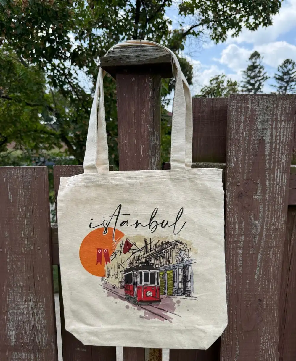 Istanbul Tote Bag: a red tram and setting sun with “İstanbul” in script.
